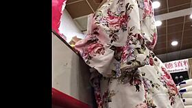 granny browses store shelves in flowing skirt spied from below