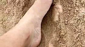 BARE FEET sink into warm sand for sensory fetish play