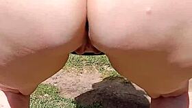 Mature blonde spreads big shaved pussy in garden