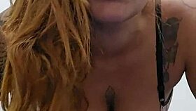 sexy redhead bares her perky tits and tight pink slit for viewers