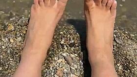 Curvy Asian beauty flaunts feet and soles on sunny beach