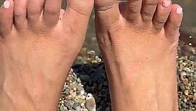 Curvy Asian beauty flaunts feet and soles on sunny beach