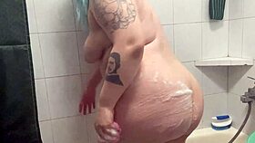 Chubby tattooed babe showers teasing her curves and wet skin beautifully