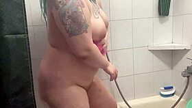 Chubby tattooed babe showers teasing her curves and wet skin beautifully