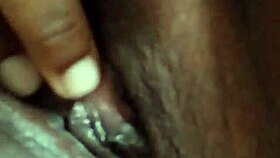 She spreads her wet ebony pussy wide fingering deeply in solo play on bed