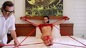 sofi wriggles bound in red ropes on bed part 2 🪢😈