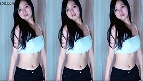 A cute Chinese girl with big tits dances seductively here.