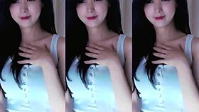 A cute Chinese girl with big tits dances seductively here.