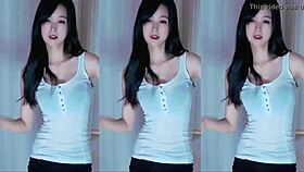 A cute Chinese girl with big tits dances seductively here.