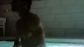 A muscular man soaks in public jacuzzi.