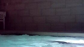 A muscular man soaks in public jacuzzi.