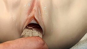 shoving that fake cock deep into her smooth shaved pussy up close