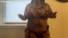 ebony hazelnutxxx lights up cigarette posing seductively in tight bikini close-up