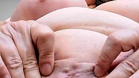 busty mature in lingerie teases her shaved pussy close up