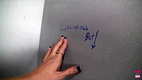 In the bathroom, can Darcie resist sucking that massive black cock through the gloryhole?