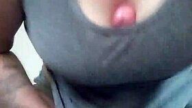 Tattooed brunette plays with dildo between her breasts casually