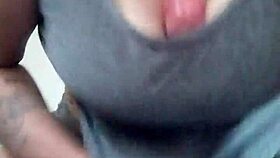 Tattooed brunette plays with dildo between her breasts casually