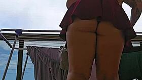 naughty maid flashes big ass under skirt balcony