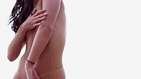 skinny kristie taylor strips bikini spreads legs beach rocks