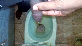 black dude lets loose pissing stream casually