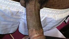 Hairy neighbor guy strokes his big black cock indoors casually