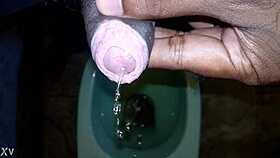 black dude lets loose pissing stream casually