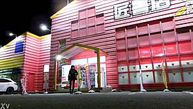 crossdresser teases in fishnet miniskirt heels at sex shop