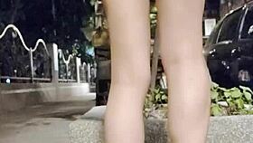 the taiwanese crossdresser ventures outdoors in flat shoes wearing just a top showing off legs