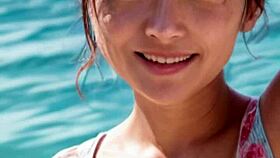 Mature model wanders the sunny beach in casual narrative stroll