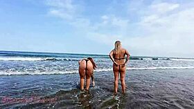 slutty babe flashes her pussy and ass on the beach with hot friend