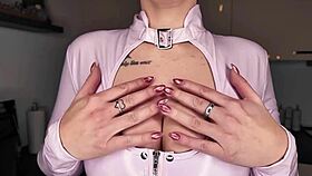 European German beauty poses naked in latex with pierced nipples and tattoos