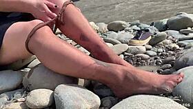 Come see my messy nylon feet up close on the riverbank in torn pantyhose