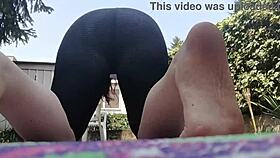 nicoletta flows through yoga poses in the garden with her dirty feet on webcam