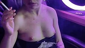 A beautiful asian lady elegantly smokes her cigarette