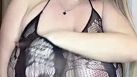 A milf in see-through clothes caresses her big natural tits slowly
