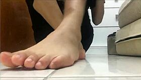 Watch her slowly peel off black socks and spit on teasing feet POV