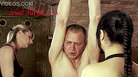 Two dominant ladies handcuff and slap his tiny cock hard