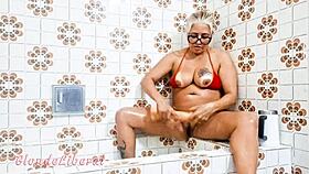 blonde milf shoves dildo in pussy bathroom pissing solo