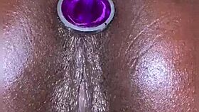 ebony slut's big pussy squirts easy from anal plug play