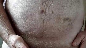 Hairy big belly mature strokes small cock to orgasm in homemade voyeur clip
