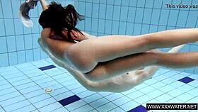 shaved brunette babe with massive tits teases underwater in the pool shower