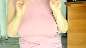 Those giant mature boobs swing free without a bra to the music in hot striptease