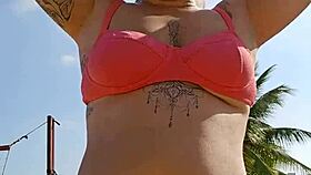 Watch me flash and tease beach hunks while filming hot video