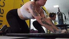 that cheeky blonde flashes her tight body cameltoe and pierced nipples right in the gym