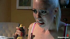 bound slave endures intense lezdom assfucking and whipping in kinky domination session