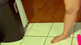 Busty Asian babe rides her pink dildo across kitchen floor