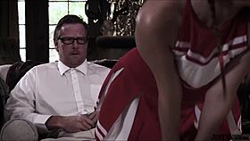 teen cheerleader practices moves with her older coach