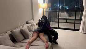 A masked person ties me and holds an object