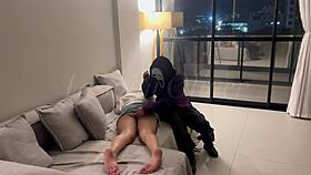 A masked person ties me and holds an object