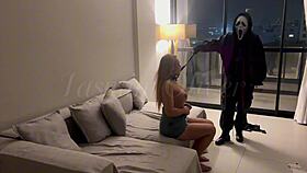 A masked person ties me and holds an object